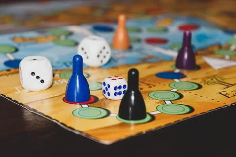 Board game on the table, on which there are colored chips and cubes Stock Photos