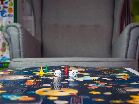 Board games concept. Dice, chips and cards on the background of the playing f Stock Photos
