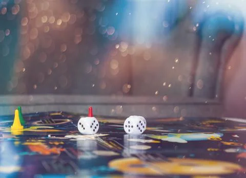 Board games concept. Dice, chips and cards on the background of the playing f Stock Photos