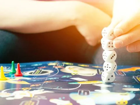 Board games concept. Dice, chips and cards on the background of the playing f Stock Photos