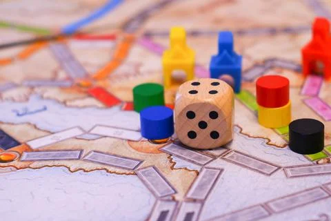 Board games, dice, colored chips on the playing field, close-up Stock Photos