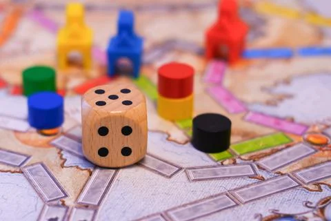 Board games, dice, colored chips on the playing field, close-up Stock Photos