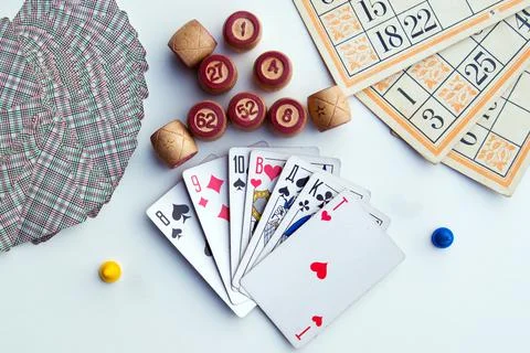 Board games on a light background playing cards, bingo, bingo cards and chips Stock Photos