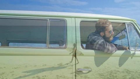 Board ghost crossing side causing driver leaning out van, raising bottle, Stock Footage 329931084