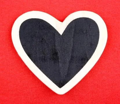 Board in heart shape on red background for message Stock Photos