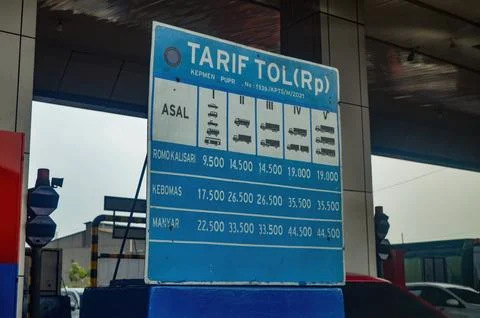 Board listing Trans Java toll road costs based on vehicle in Surabaya, indo.. Stock Photos