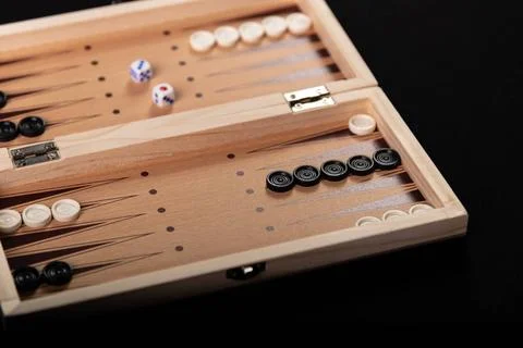  Board for playing backgammon with pieces and dice on a black background. ... 写真素材