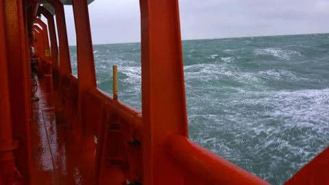 Board ship in storm. Red side of vessel, green sea. High waves. Strong pitching Stock Footage 169843496