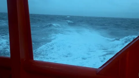 Board ship in storm. Strong wind breaks wave. Red side of vessel and green sea. Stock Footage 224085343