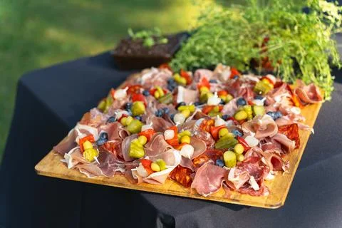 Board with various types of meat and sausages, gherkins and olives for a bu.. Stock Photos