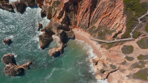 Board walk down to beach ocean ripples of ponta da piedade and praia da Stock Footage 247876668