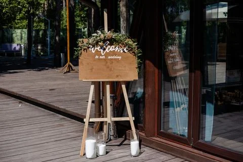 Board, which stands on the grass with wedding inscription. Mockup for invitation 스톡 사진