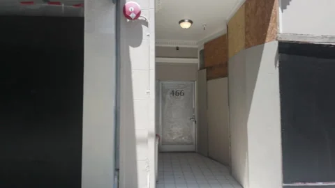 Boarded up store doors and windows, pan shot. San Francisco, California, USA. Stock Footage 280140540