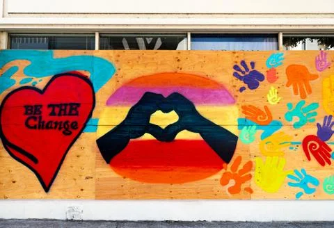 Boarded up window painted with artwork Foto stock
