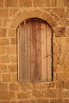 Boarded up window in stone wall Stock Photos