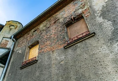 Boarded Up Windows On Old Brick Building With Gutter Stock Photos