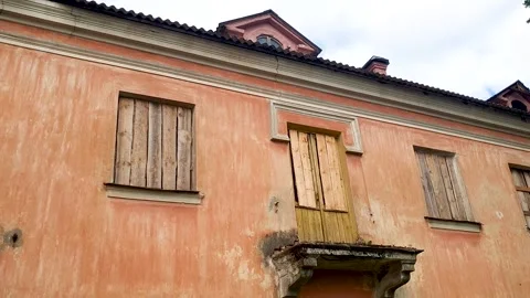 Boarded-up windows in an old building. A mysterious building, an old Stock Footage 342037406