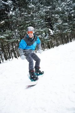 Boarder freeride tyrough the mountain while snow falling Stock Photos
