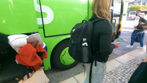 Boarding bus ticket passengers waiting in queue loading luggage in trunk Stock Footage 229194980