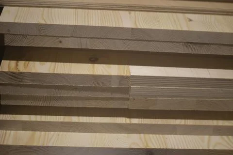 Boards in the carpentry workshop. The tree lies in a pile. Stock Photos