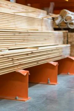 Boards on a rack in a construction store. Construction and repair concept. ve Stock Photos