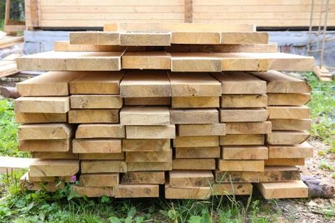 Boards in stack against house Stock Photos