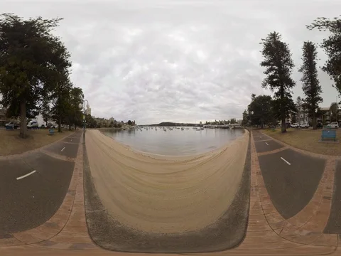 Boardwalk overlooking boats and sandy bay 360 Standing height Stock Footage 80359554