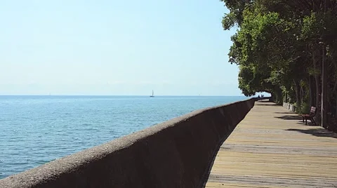 Boardwalk path sailboat trees summer 01svv Stock Footage 46902407