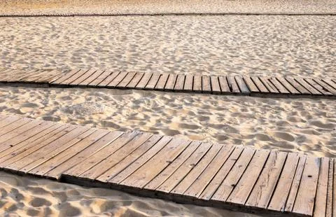 Boardwalk on a sandy beach Stock Photos