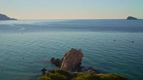 Boat activities take place during the sunny day at the beach by the rocky s.. Stock Footage 340190903