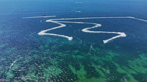 Boat activity on ocean water with waves and trails in blue Stock-Footage 339652801