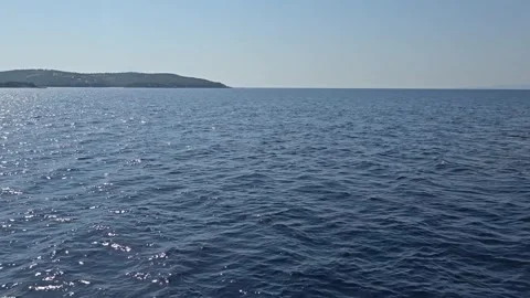 Boat anchor and deep blue sea view while sailing past islands Vídeos de archivo 328904262