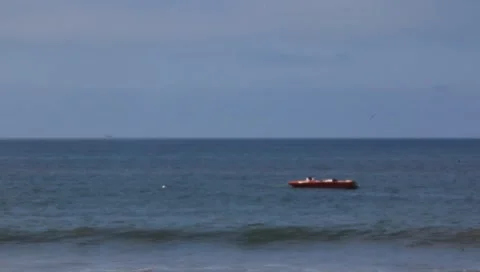 Boat at Anchor off beach Stock Footage 1117866