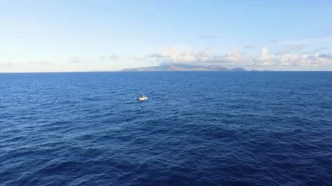 Boat and kayak in the ocean between Molokai Island and Oahu Island, Hawaii Stock Footage 239623908