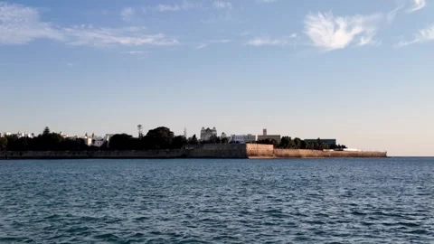 Boat approach to Baluarte de la Candelaria at sunset, Cadiz, Spain Stock Footage 341624475