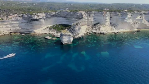 A boat approaches a large rock Stock Footage 138324017