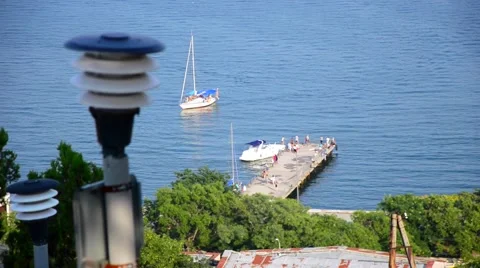 The boat is approaching to the pier where there are people Stock Footage 54928244