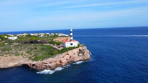 Boat approaching portocolom lighthouse in mallorca Stock Footage 296530772