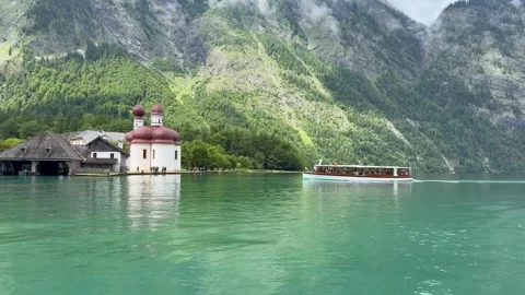 Boat arrives at St. Bartholomew stop. Panoramic view of Konigssee Lake. Germany Stock-Footage 337881914