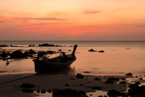 Boat on the beach at sunset Stock Photos