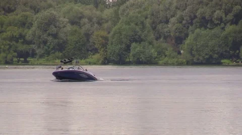 Boat begin to float and drag water-skier by the river Stock Footage 67866150