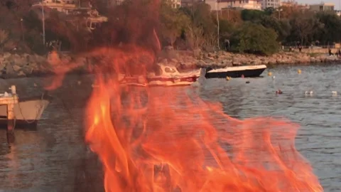Boat behind the flames Stock Footage 144341197