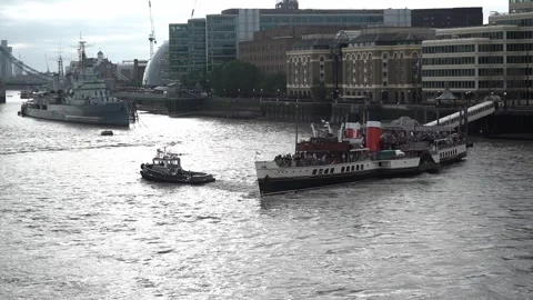Boat Being Pulled Past HMS Belfast And Tower Bridge In London Video stock 253667027