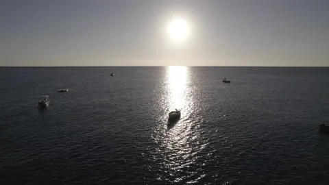 Boat beneath a setting sun Video stock 197111601