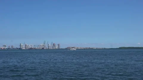 Boat in Biscayne bay with Miami cargo shipping dock in background. Stock Footage 219977103