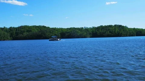 A boat on a blue river Видео 75596879