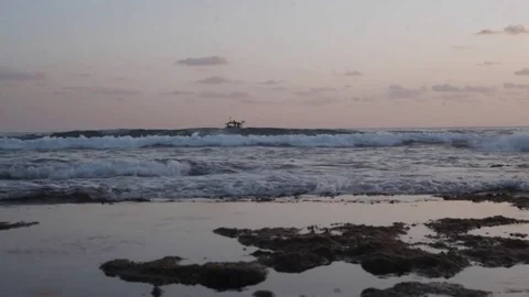 Boat bobs on the waves in the sea Stock Footage 82648361