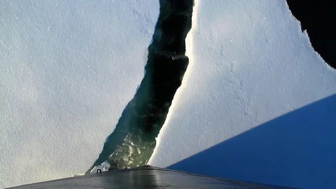 Boat breaking floating ice in Antarctica 3 Stock Footage 87699222