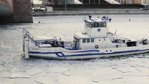 Boat Breaking up Ice on a River Stock Footage 76384475