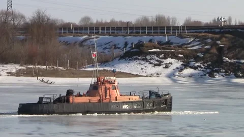Boat breaks the ice on the River in the spring on a sunny day. Stock Footage 150122835